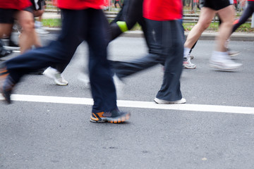 People running in city marathon on a street