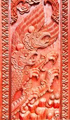 Garuda carved on temple door,state symbol of thailand
