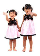 A cheerful studio portrait of two young Asian children laughing joyfully while posing for the camera. Both kids express pure happiness and fun, set against a clean white background. Perfect for themes