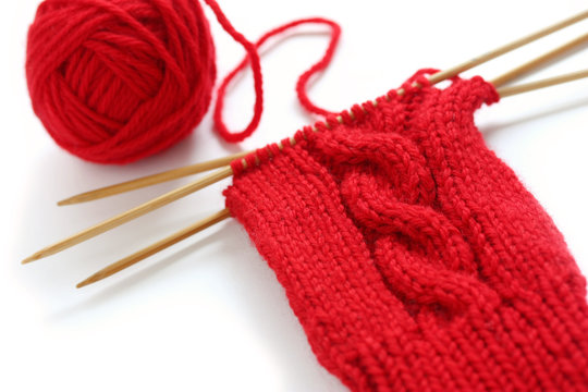 knitting image, a red yarn ball with noodles