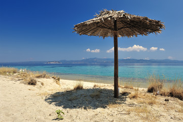 Beach umbrella on a sunny day, sea in background