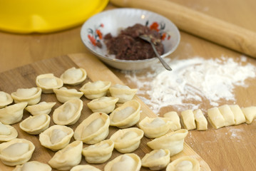 Fototapeta na wymiar dough and stuffing, cooking Russian meals dumplings