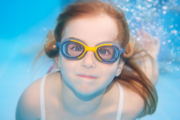 Fototapeta premium children girl funny underwater with goggles