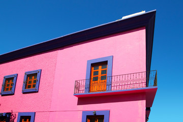 Mexican pink house facade  wooden doors