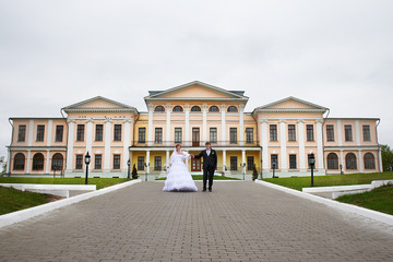 Bride and groom at wedding  walk near palace
