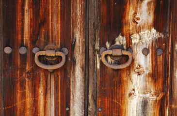 old wooden door with metal handles detail