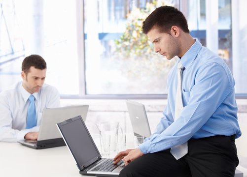Young businessmen working on laptop