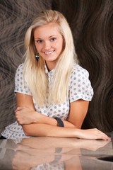 Fototapeta premium Smiling blond girl in white shirt