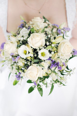 Bride holding beautiful wedding flowers bouquet