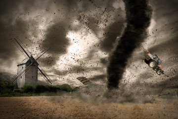 Large tornado over a wind mill