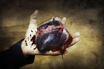 Halloween concept. heart in hand with blood