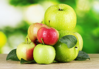 Fresh organic apples on wooden table isolated on white