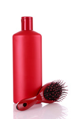 Shampoo bottles and hair brush on white