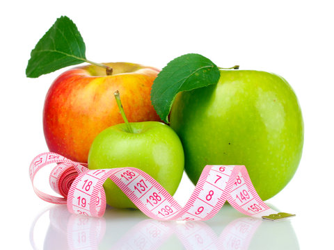 Concept of a diet. Many fresh ripe apples with measuring tape