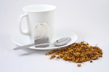 White Tea Cup, Tea Bag and Loose Herbal Tea on White Background