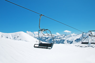 Ski lift chairs on bright winter day