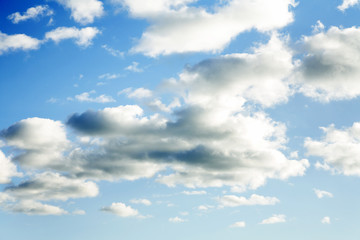 Naklejka na ściany i meble Fluffy clouds in blue sky