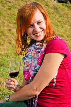 Young woman drinking wine outdoors