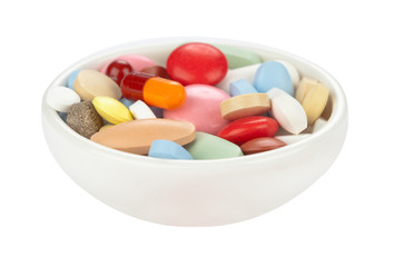 Colored pills in white bowl