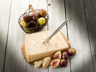 parmesan cheese over cutting board and figs