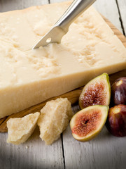 parmesan cheese over cutting board and figs