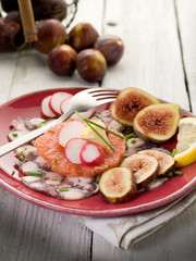 octopus carpaccio over grapefruit with figs and  radish