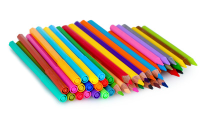Bright markers and crayons isolated on white