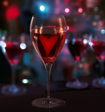 A glass of red wine, with heart. Blurred City Lights