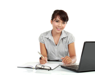 business woman working at her desk with a laptop and paperwork