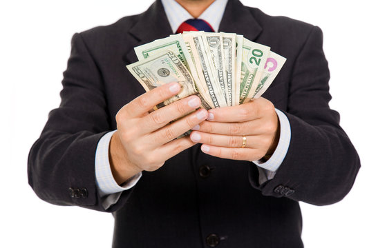 Image of a business man holding money, isolated on white