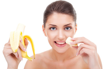 woman eating banana and smiling