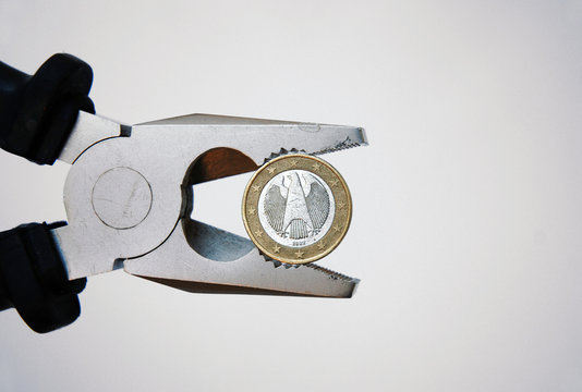 Money under pressure a german euro coin concept symbol