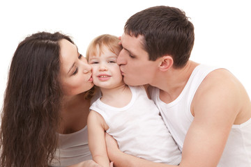 Happy family, mother, father and daughter on the white bed