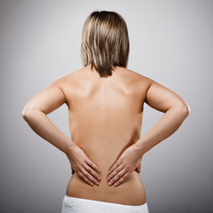 Fototapeta premium Woman massaging pain back