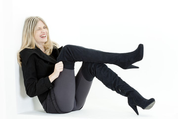 Fototapeta premium sitting woman wearing fashionable black boots