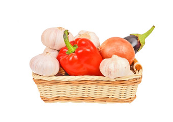Vegetables in a wattled basket, isolated on white background