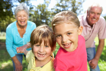 Senior couple on country walk with grandchildren