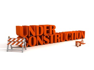 under constraction text with barrier and road traffic cones