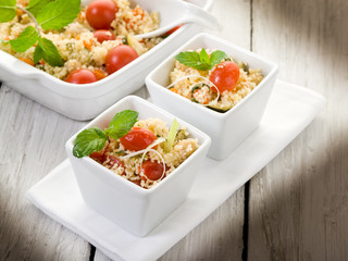 vegetable couscous with cerry tomatoes and mint leaf