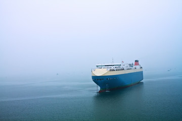 Cruise stops in the sea in a foggy day