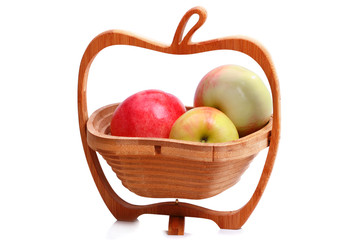 Wooden vase with ripe apples