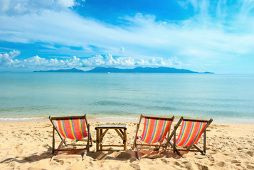 Fototapeta na wymiar Chairs on beach near with sea