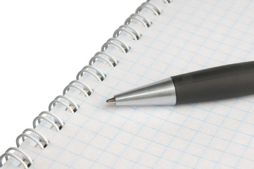 blank exercise book with pen
