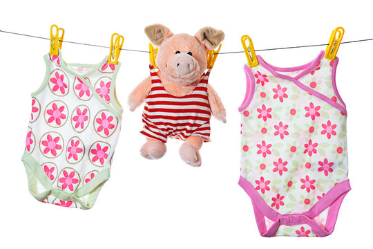 Baby Sleepers And Pig On The Clothesline, Studio Isolated On Whi