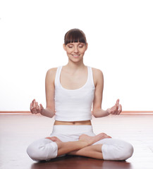 A young and fit meditating Caucasian brunette woman