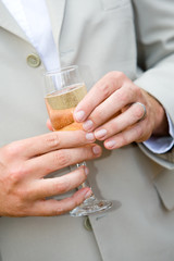 A caucasian man holding a glass of champagne