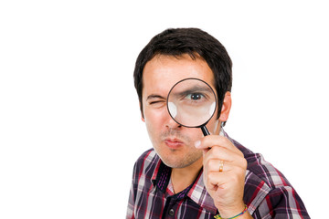 Funny image of a young man looking through magnifying glass, iso