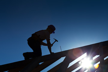 Fototapeta Builder or carpenter working on the roof obraz