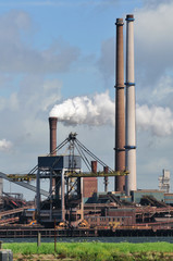 Factory with smoke on sky