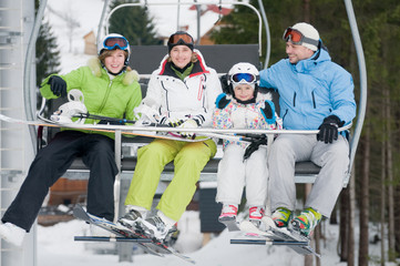 Ski lift - happy family on ski  vacation